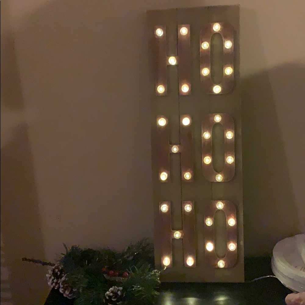 Ho ho ho sign that lights up on wood can be hung